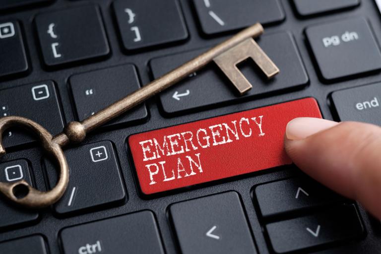 A computer-generated image of a computer keyboard with a specific red button titled Emergency Plan.