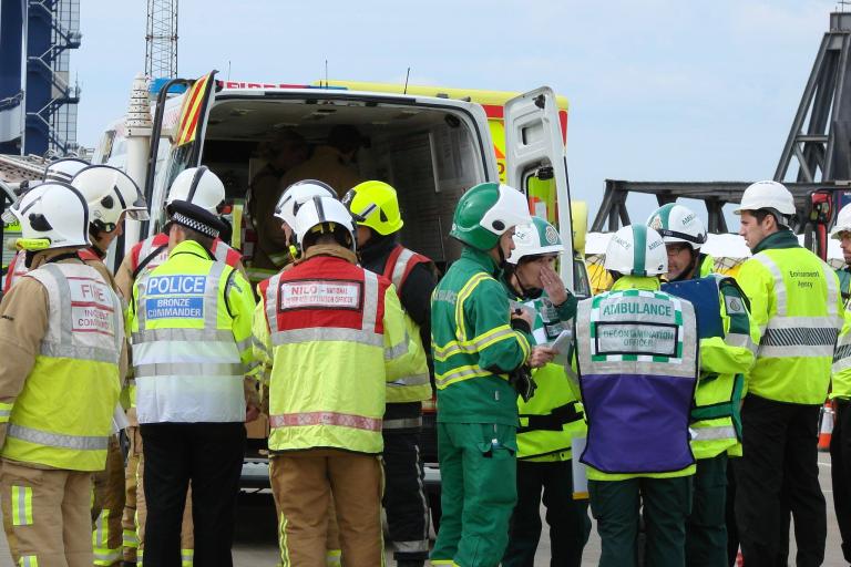 A huddle of Commanders/Managers from various agencies - all part of the Local Resilience Forum.